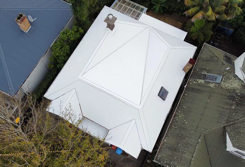 A white long run roof on an old residential villa.